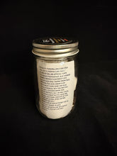 Load image into Gallery viewer, Jar with a label on a black background
