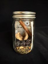 Load image into Gallery viewer, Glass jar with dried herbs and spices on a black background

